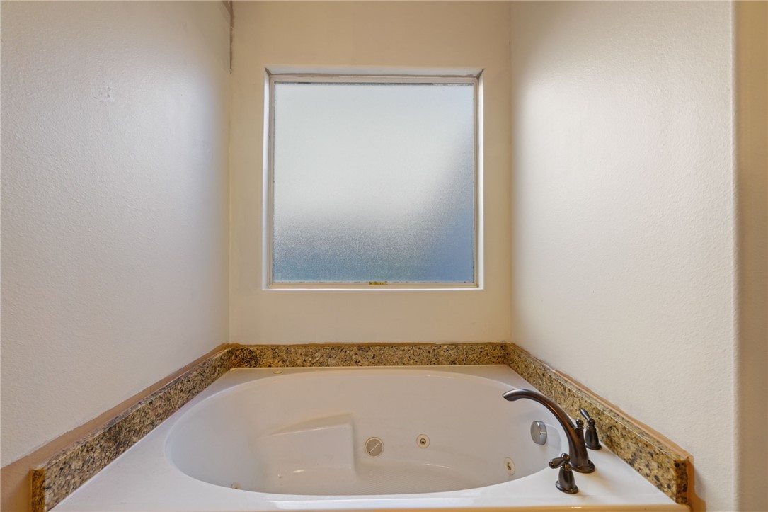 8226 Azimuth Court Corpus Christi, TX 78414 - Photo 16 of 32 a bathroom with a tub and a window