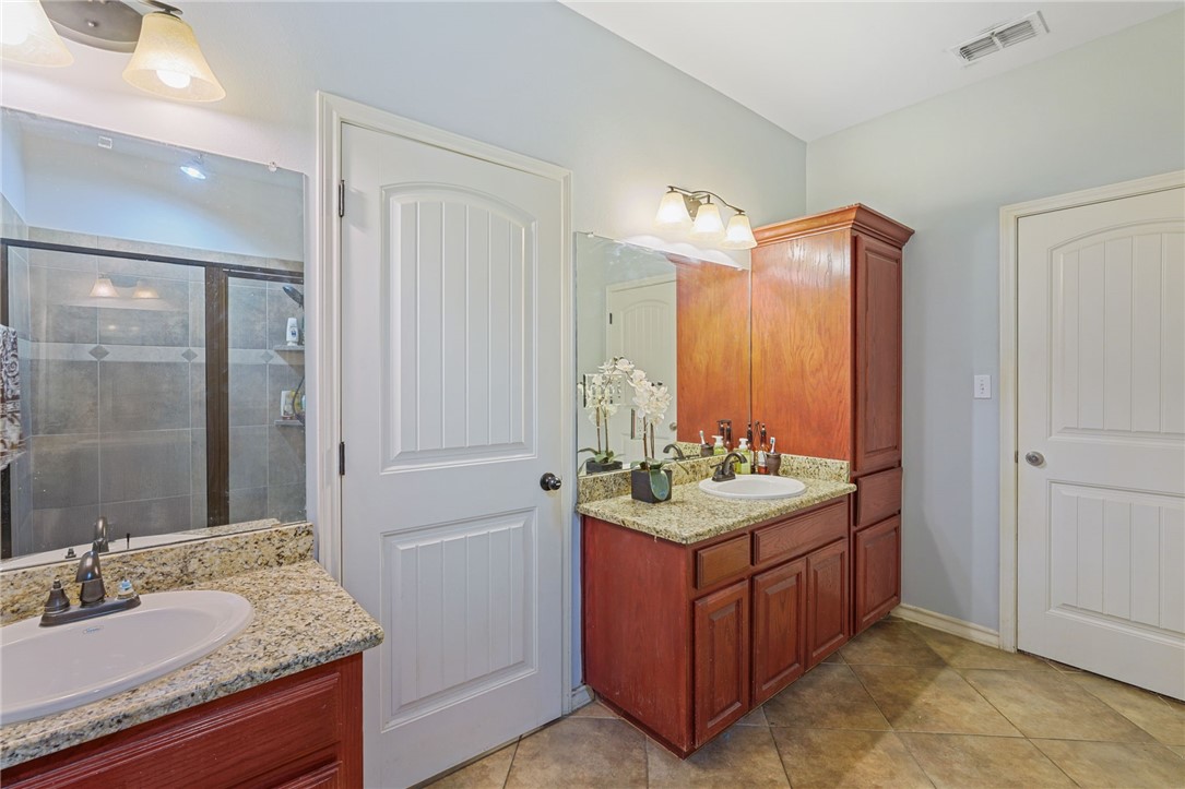 8226 Azimuth Court Corpus Christi, TX 78414 - Photo 17 of 32 a bathroom with a sink double vanity and a mirror