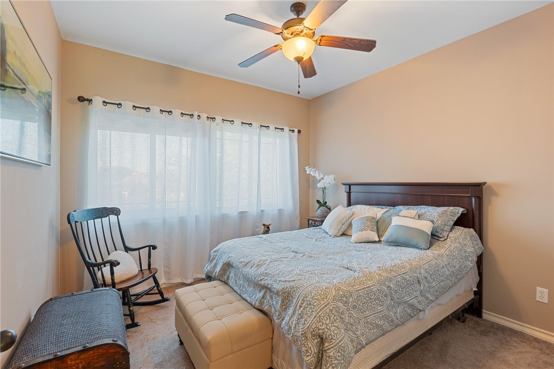 8226 Azimuth Court Corpus Christi, TX 78414 - Photo 19 of 32 a bedroom with a bed and a chair