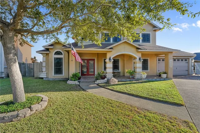 a front view of a house with garden
