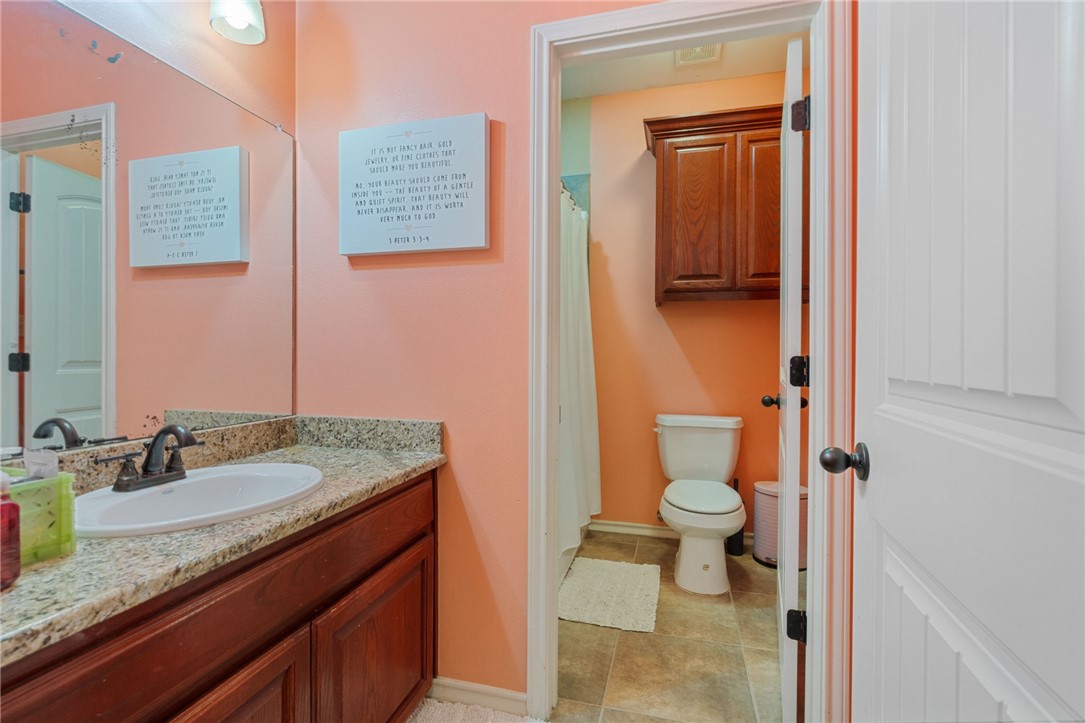 8226 Azimuth Court Corpus Christi, TX 78414 - Photo 21 of 32 a bathroom with a granite countertop sink toilet and shower