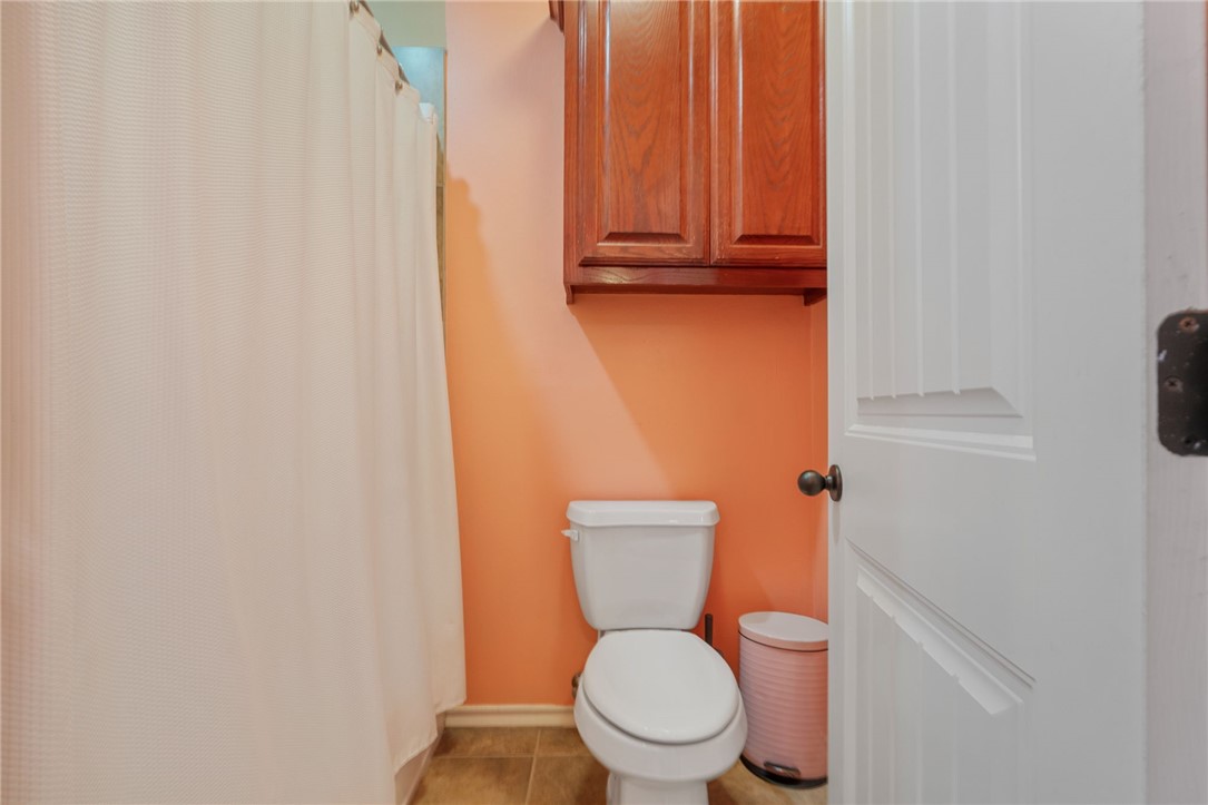 8226 Azimuth Court Corpus Christi, TX 78414 - Photo 22 of 32 a white toilet sitting next to a white cabinet
