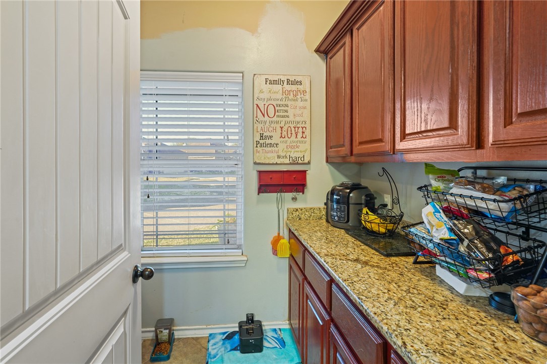 8226 Azimuth Court Corpus Christi, TX 78414 - Photo 25 of 32 a kitchen with stainless steel appliances granite countertop a sink window and cabinets