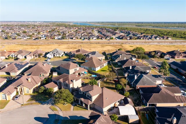 an aerial view of residential houses with yard