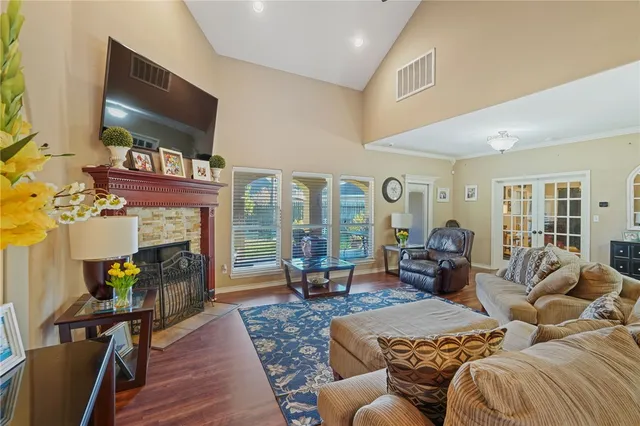 a living room with furniture a flat screen tv and a fireplace
