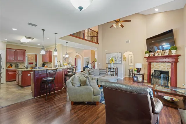 a living room with furniture ceiling fan and a rug