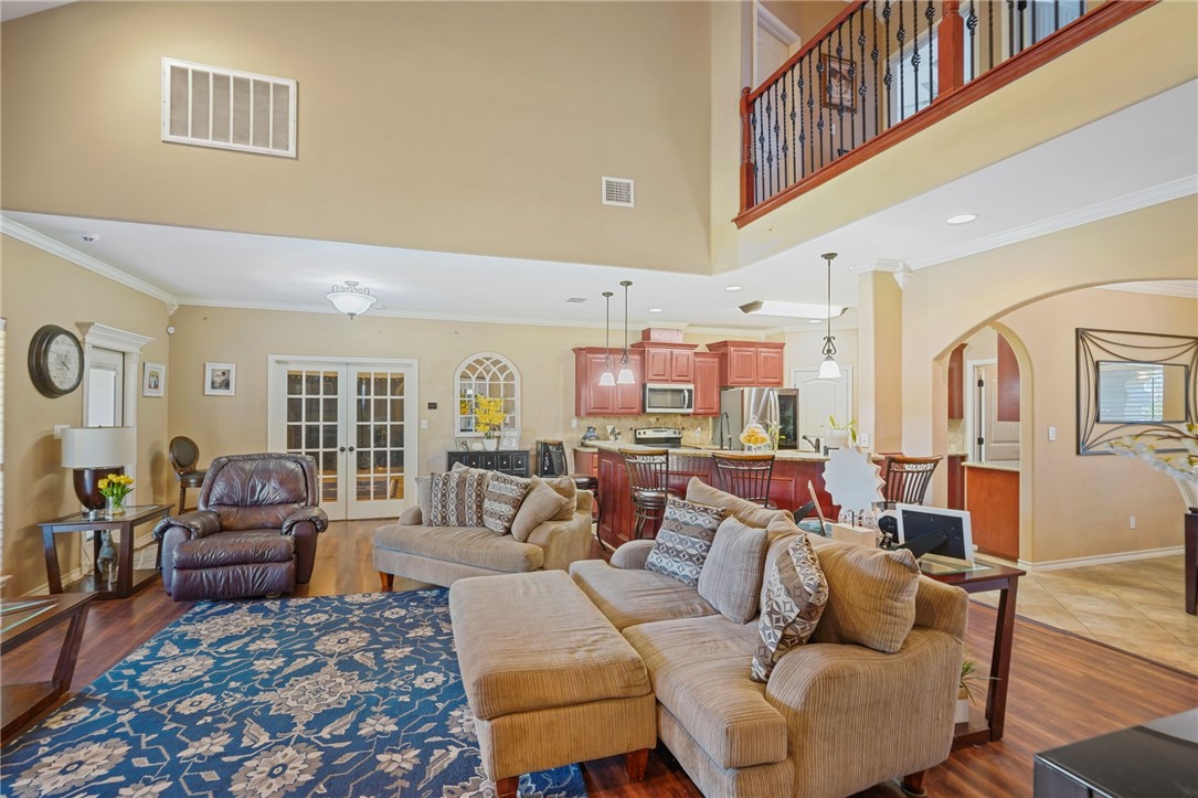 8226 Azimuth Court Corpus Christi, TX 78414 - Photo 8 of 32 a living room with furniture ceiling fan and a rug