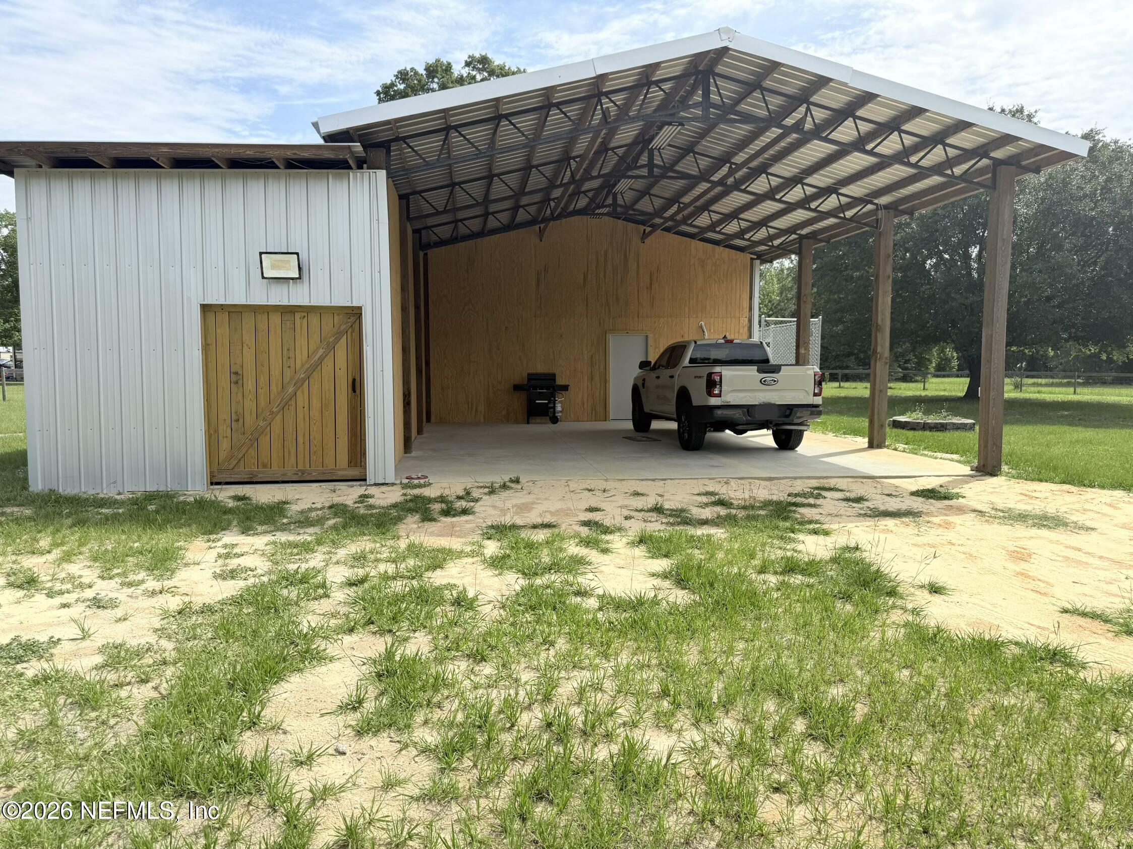 204 Comer Road Palatka, FL 32177 - Photo 14 of 15 a view of a house with backyard porch and sitting area