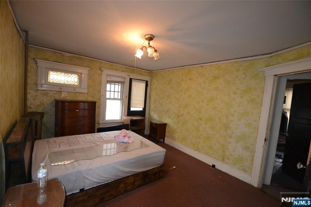 86 Montross Avenue Rutherford, NJ 07070 - Photo 11 of 23 a bedroom with a bed and a chandelier