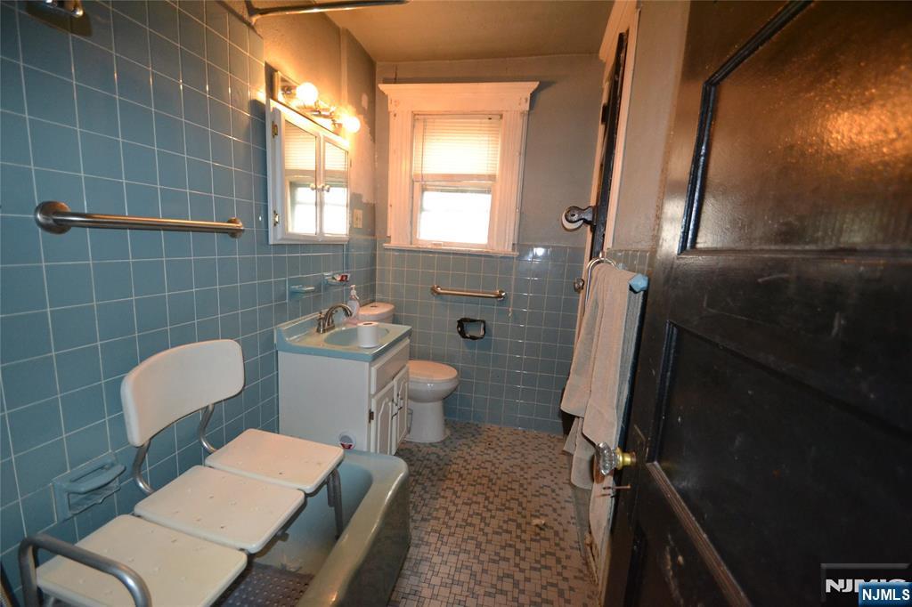 86 Montross Avenue Rutherford, NJ 07070 - Photo 13 of 23 a bathroom with a sink a toilet a mirror and shower