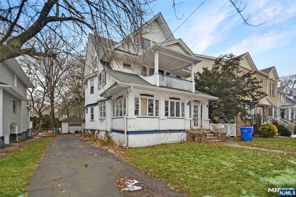 86 Montross Avenue Rutherford, NJ 07070 - Photo 2 of 23 a front view of a house with a garden