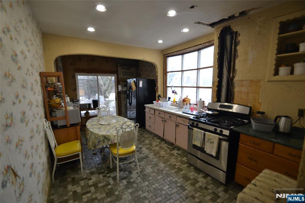 86 Montross Avenue Rutherford, NJ 07070 - Photo 10 of 23 a kitchen with stainless steel appliances granite countertop sink stove top oven and cabinets