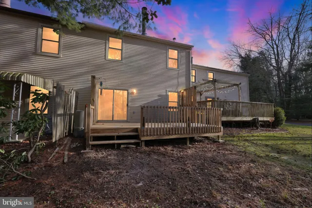 a backyard of a house with barbeque oven table and chairs