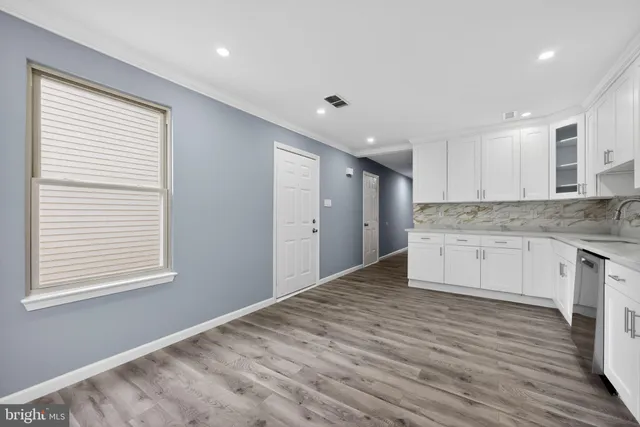 a kitchen with granite countertop white cabinets and white appliances