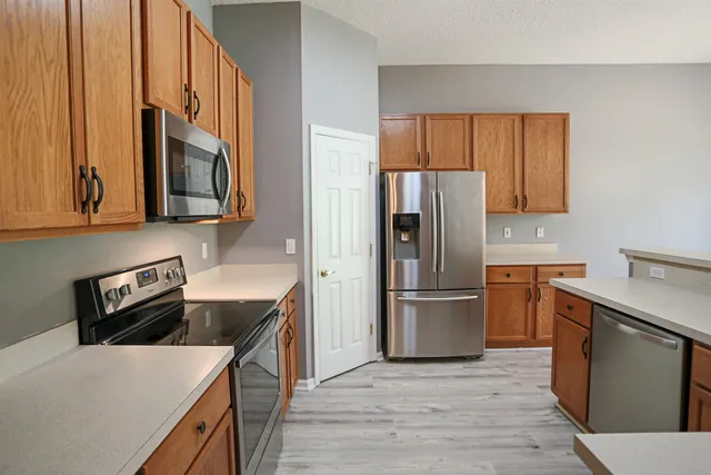 a kitchen with a refrigerator stove and oven