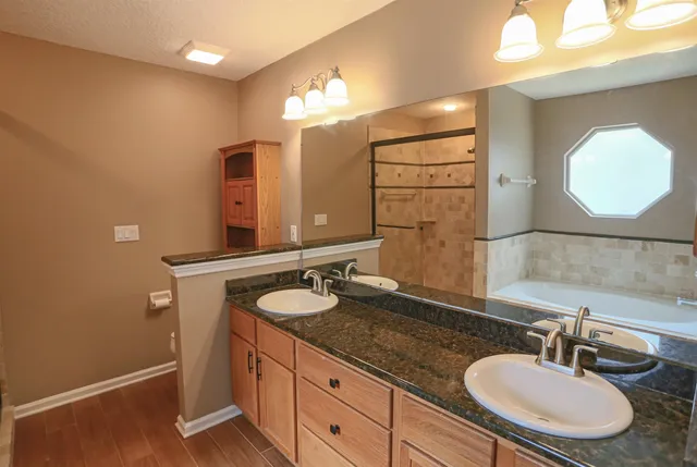 a bathroom with a bathtub and a shower