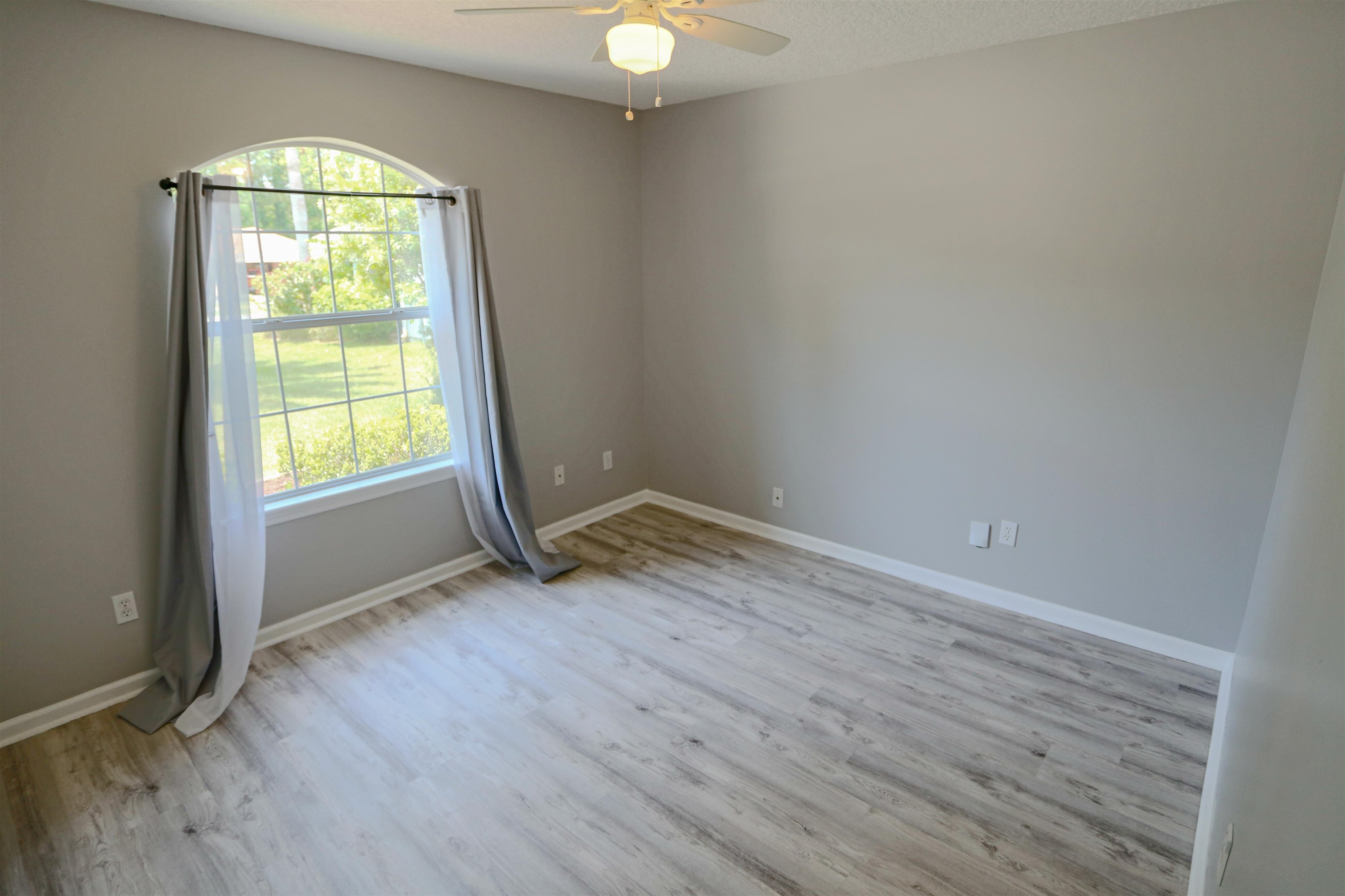 1768 Keswick Road St. Augustine, FL 32084 - Photo 19 of 30 an empty room with wooden floor and windows