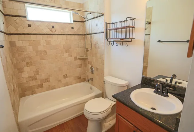a bathroom with a shower a toilet and bathtub
