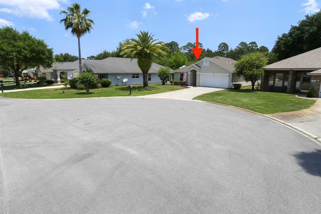 a yellow house with trees in front of it