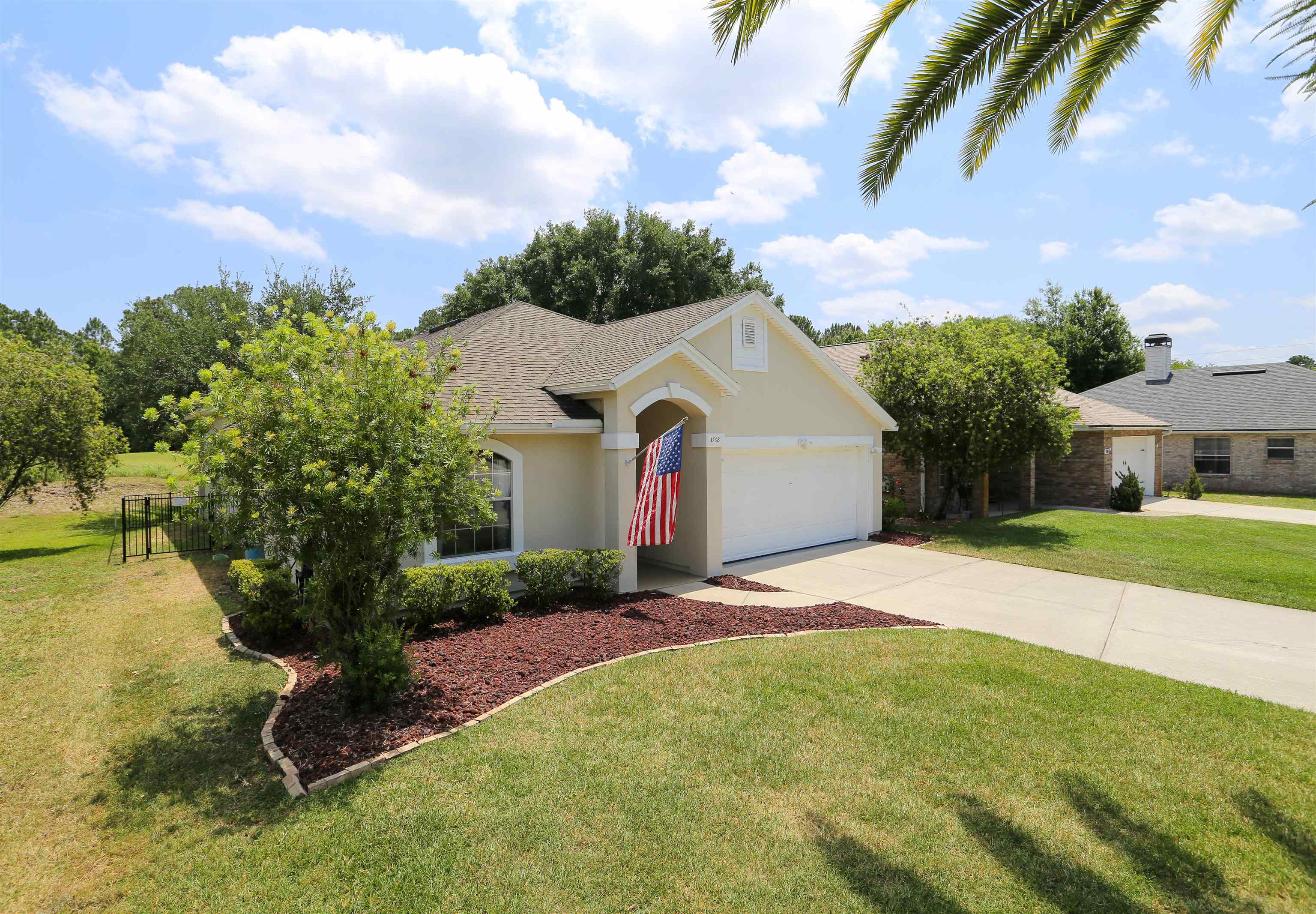 1768 Keswick Road St. Augustine, FL 32084 - Photo 4 of 30 a front view of a house with garden