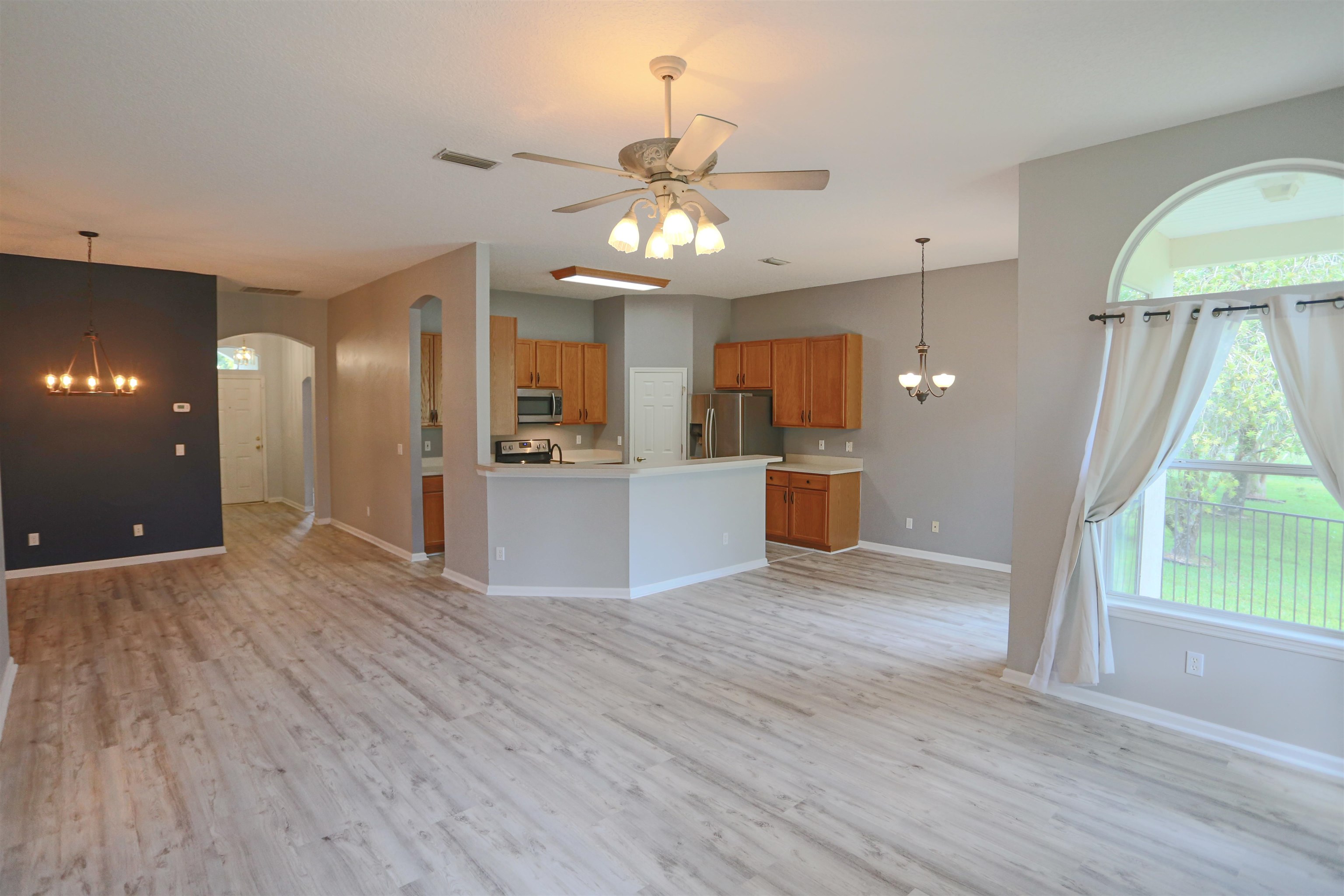 1768 Keswick Road St. Augustine, FL 32084 - Photo 7 of 30 a view of a kitchen with wooden floor and a ceiling fan