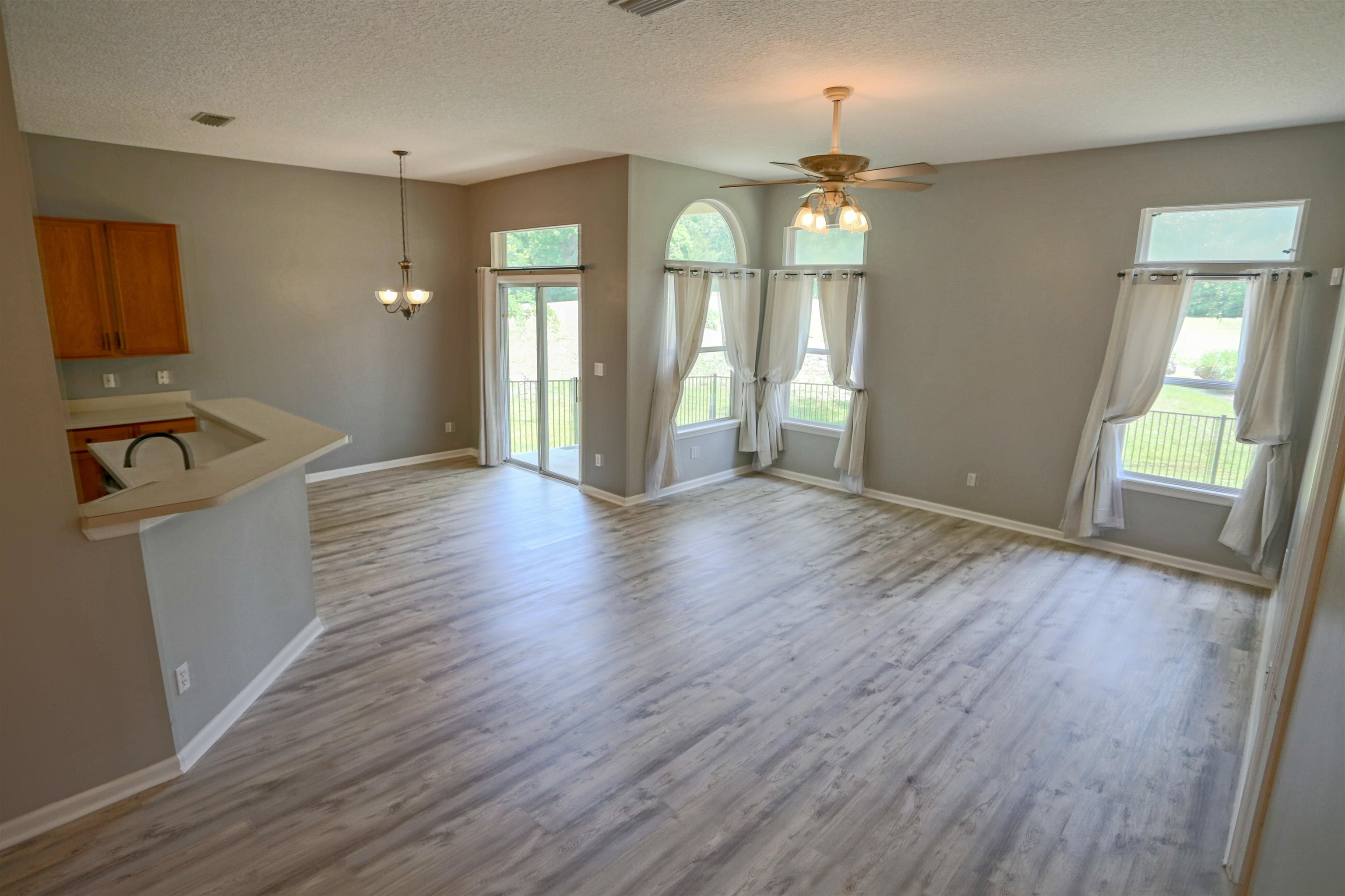 1768 Keswick Road St. Augustine, FL 32084 - Photo 10 of 30 wooden floor in an empty room with a window