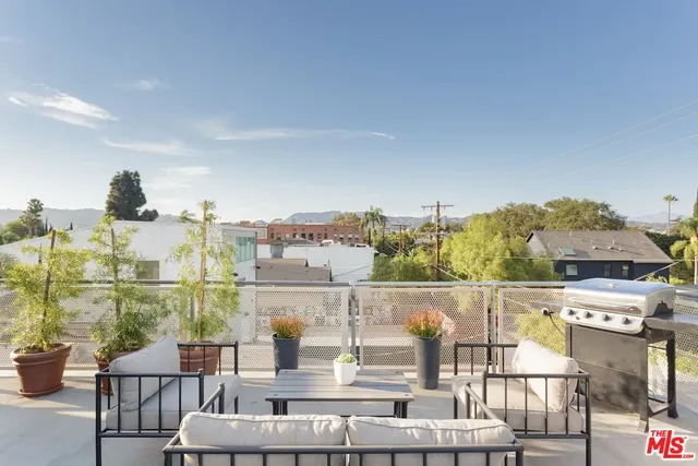 a view of a walk in closet and wooden floor