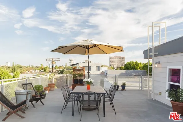 a view of a backyard with plants and a fountain