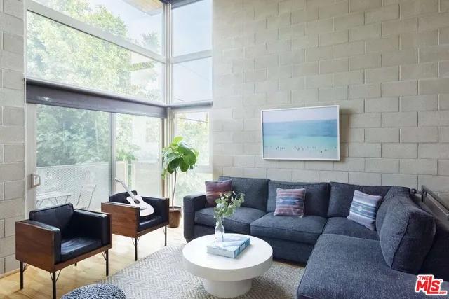 a kitchen with stainless steel appliances a sink a stove a refrigerator and cabinets