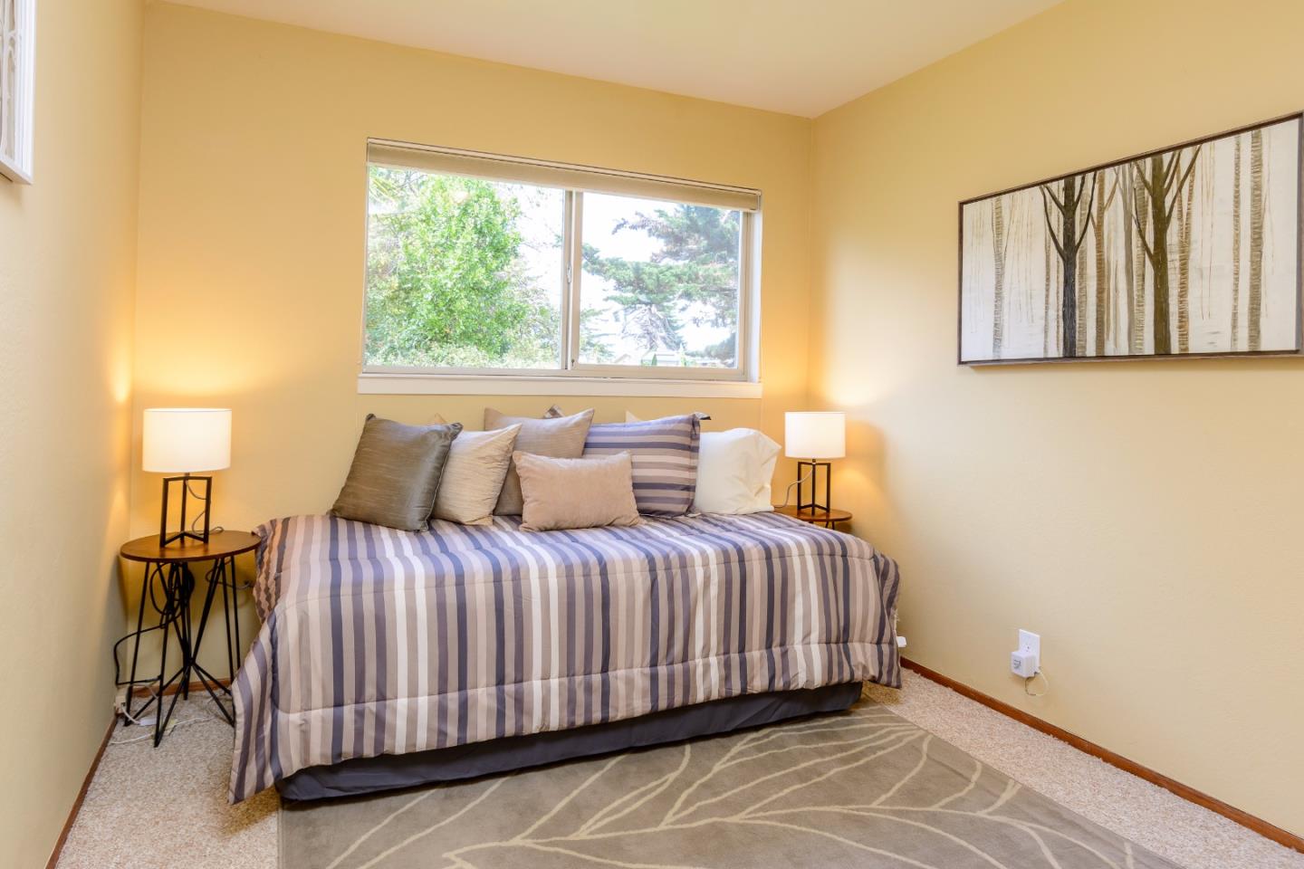 416 Cullen Road Pacifica, CA 94044 - Photo 13 of 18 a bedroom with a bed and window