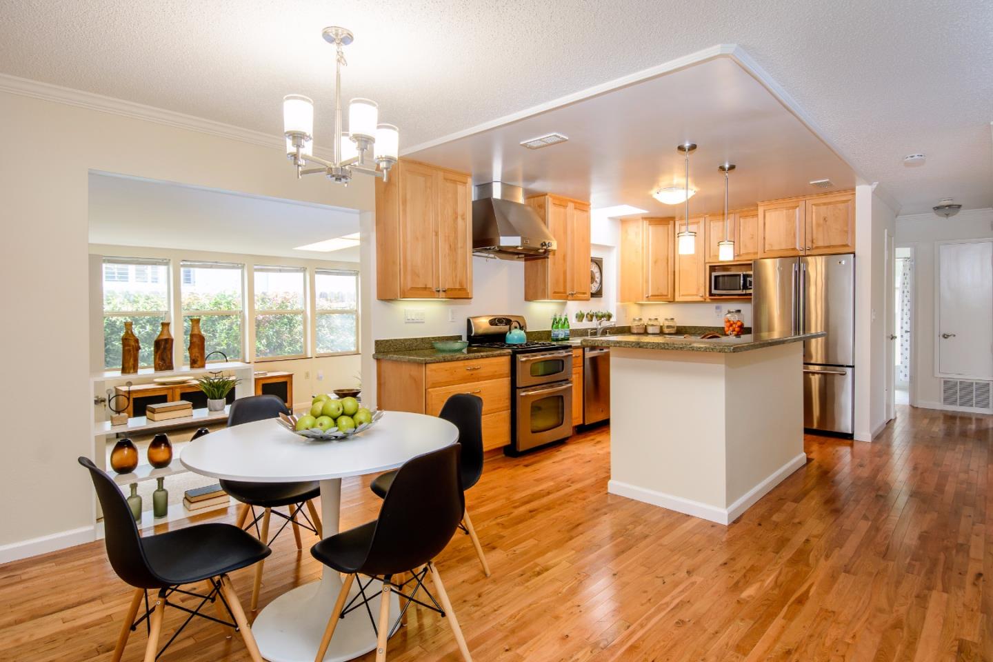 416 Cullen Road Pacifica, CA 94044 - Photo 6 of 18 a large kitchen with a table and chairs