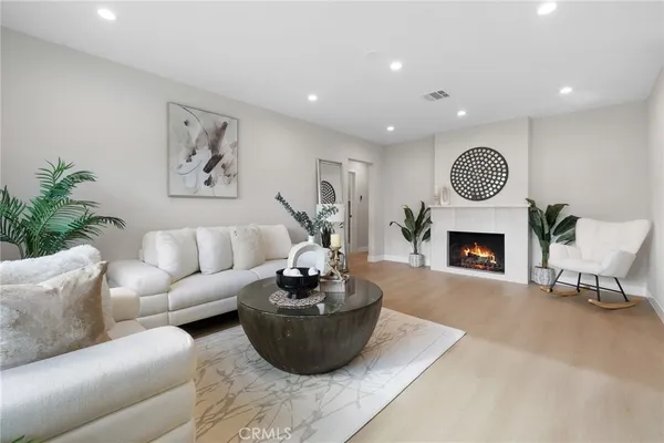 a living room with furniture a fireplace and a fireplace
