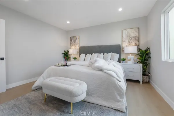 a bed room with a bed and a potted plant