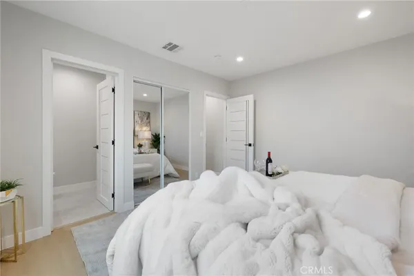 a bedroom with a bed and a mirror