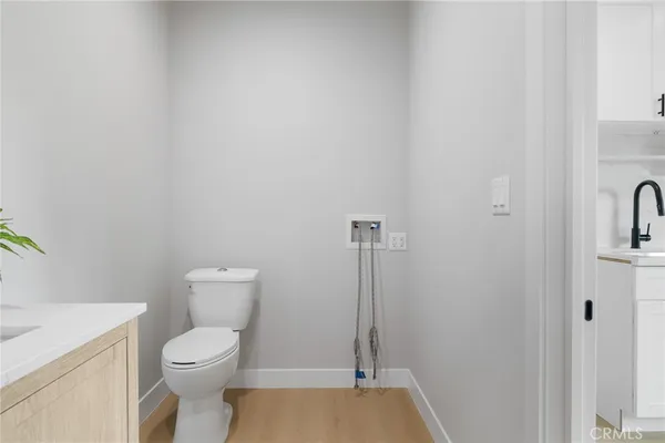 a white toilet sitting next to a sink