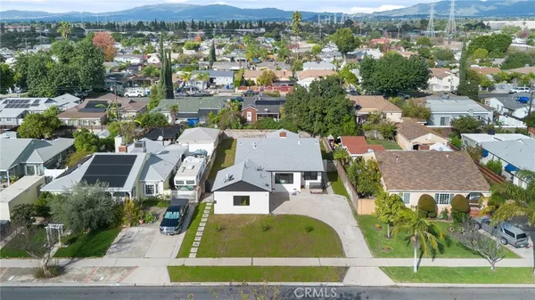 an aerial view of residential houses with outdoor space and city view