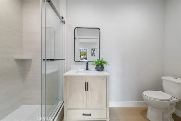 a bathroom with a toilet a sink and mirror