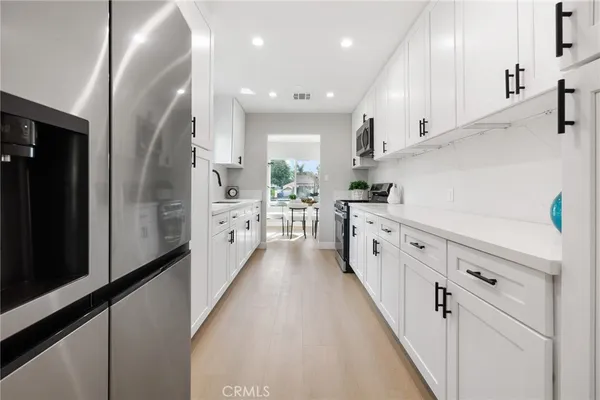 a large white kitchen with lots of counter space