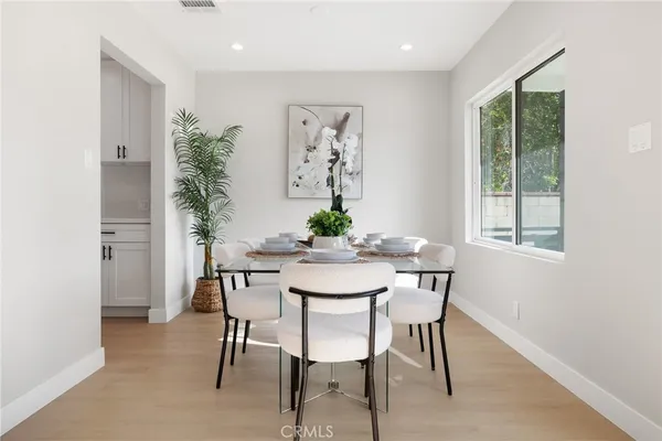 a view of a dining room with furniture window and wooden floor