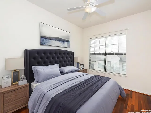 a bedroom with a large bed and a window