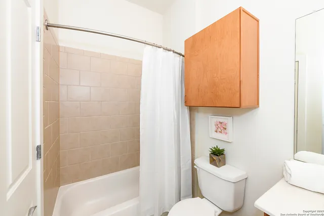 a white toilet sitting next to a bathroom sink