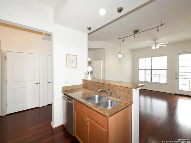 a view of a sink a window and wooden floor