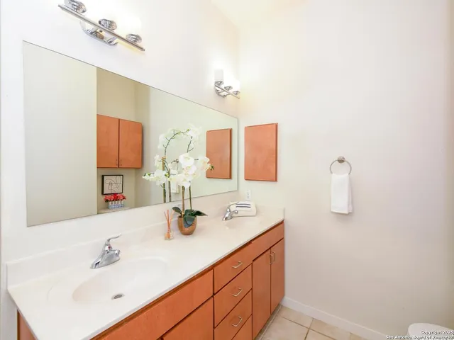 a bathroom with a sink vanity and mirror