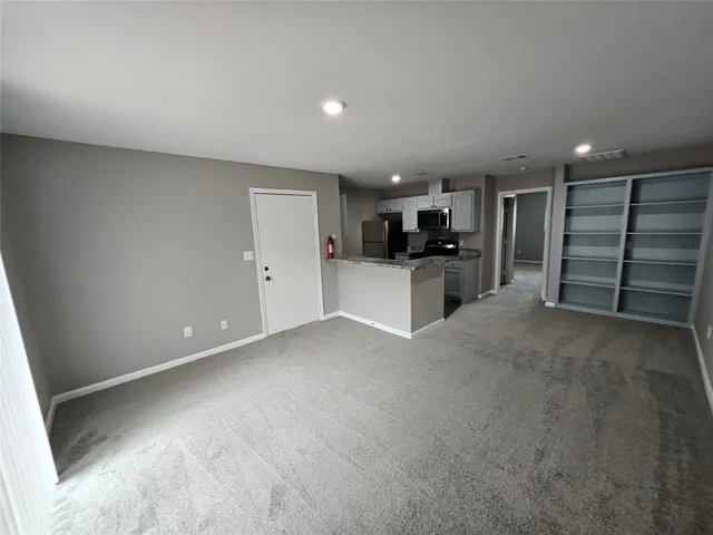 a view of a kitchen with furniture and a kitchen