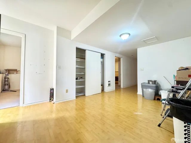 a kitchen with a stove a refrigerator and a view of living room