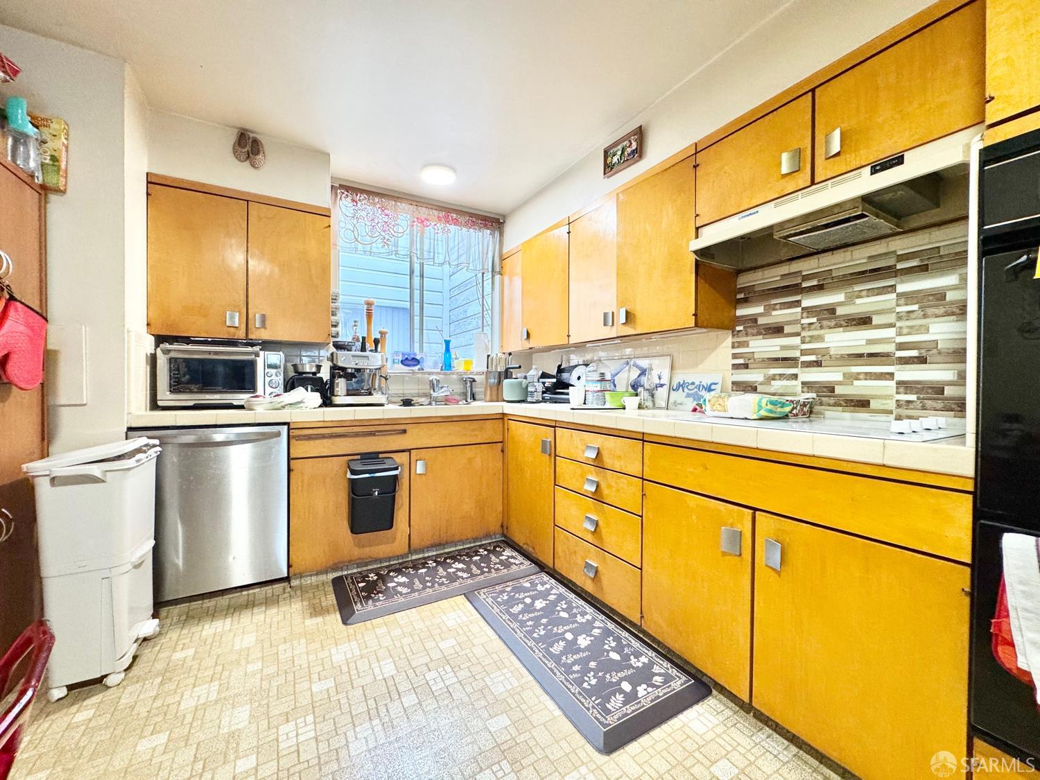 740-742 37th Avenue San Francisco, CA 94121 - Photo 10 of 20 a kitchen with sink cabinets and window