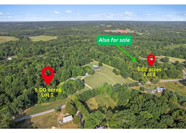 a picture of a wall with a white comforter and pillows