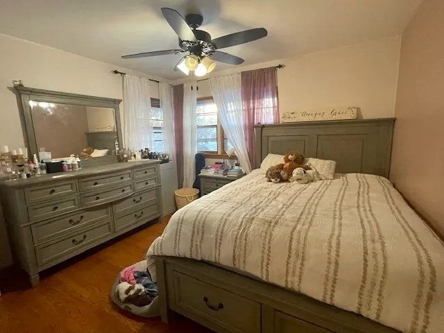 a bedroom with a bed and a mirror on dresser