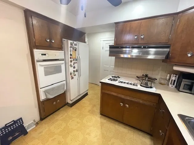a kitchen with a stove and a refrigerator