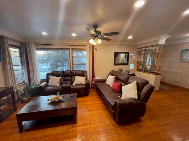 a living room with furniture fireplace and a large window